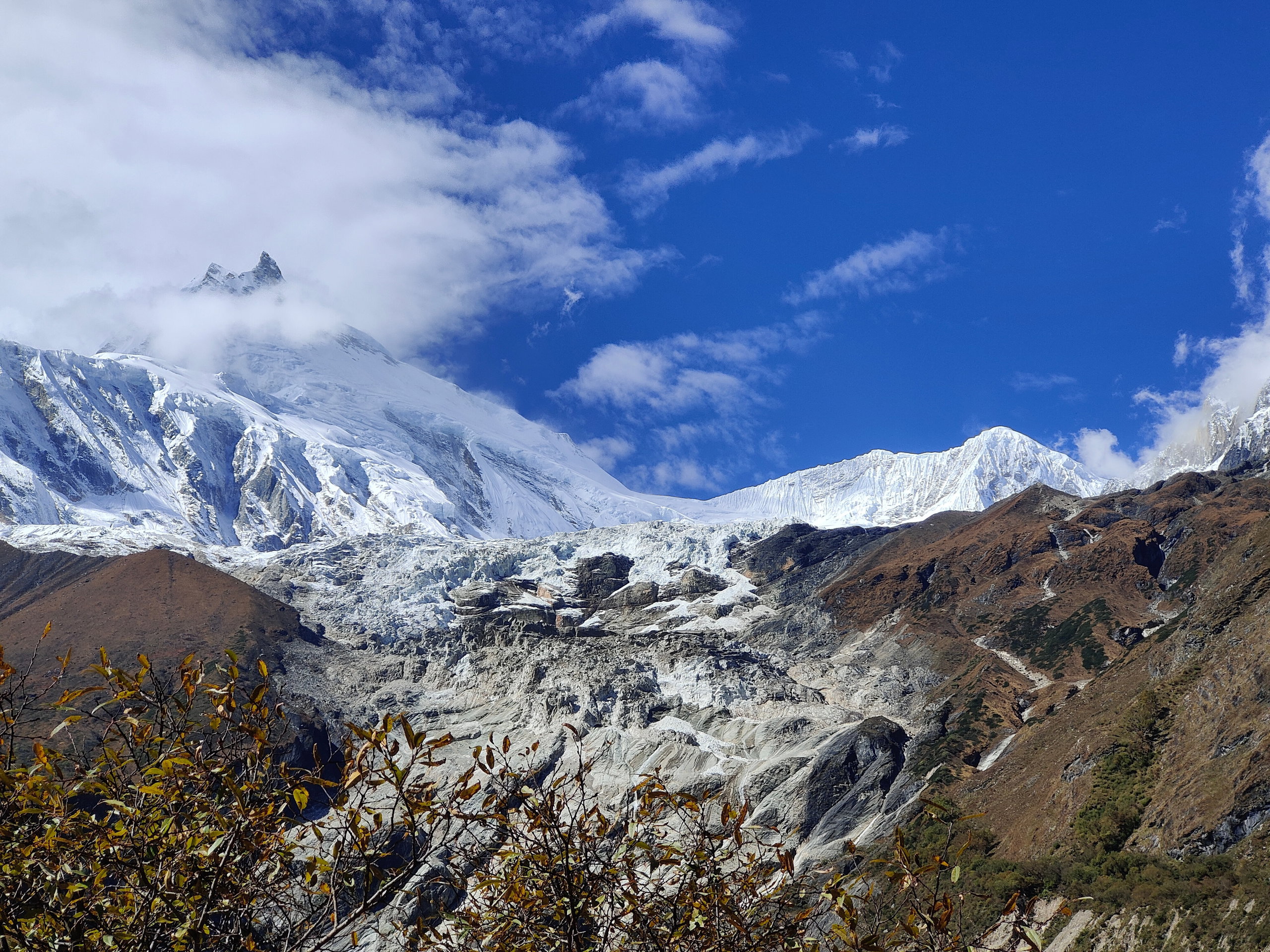 Manaslu mountain and its glacier seen from the Manaslu Base Camp trail