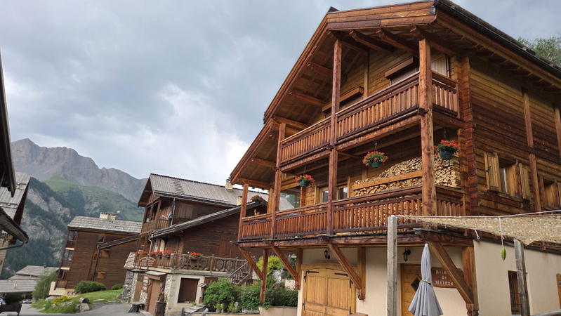 Large wooden chalet with balconies and flower baskets in Saint Véran.