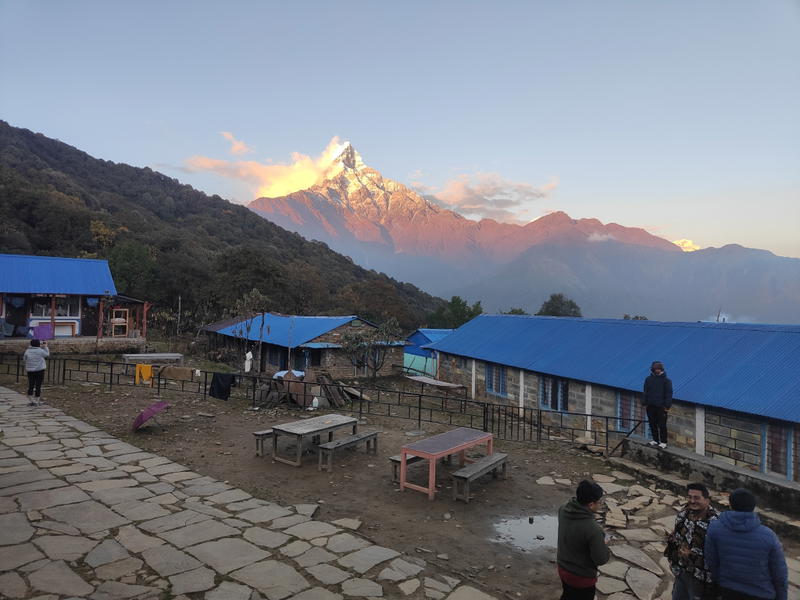 Tea houses at Low Camp against the backdrop of a snow-capped peak at dusk