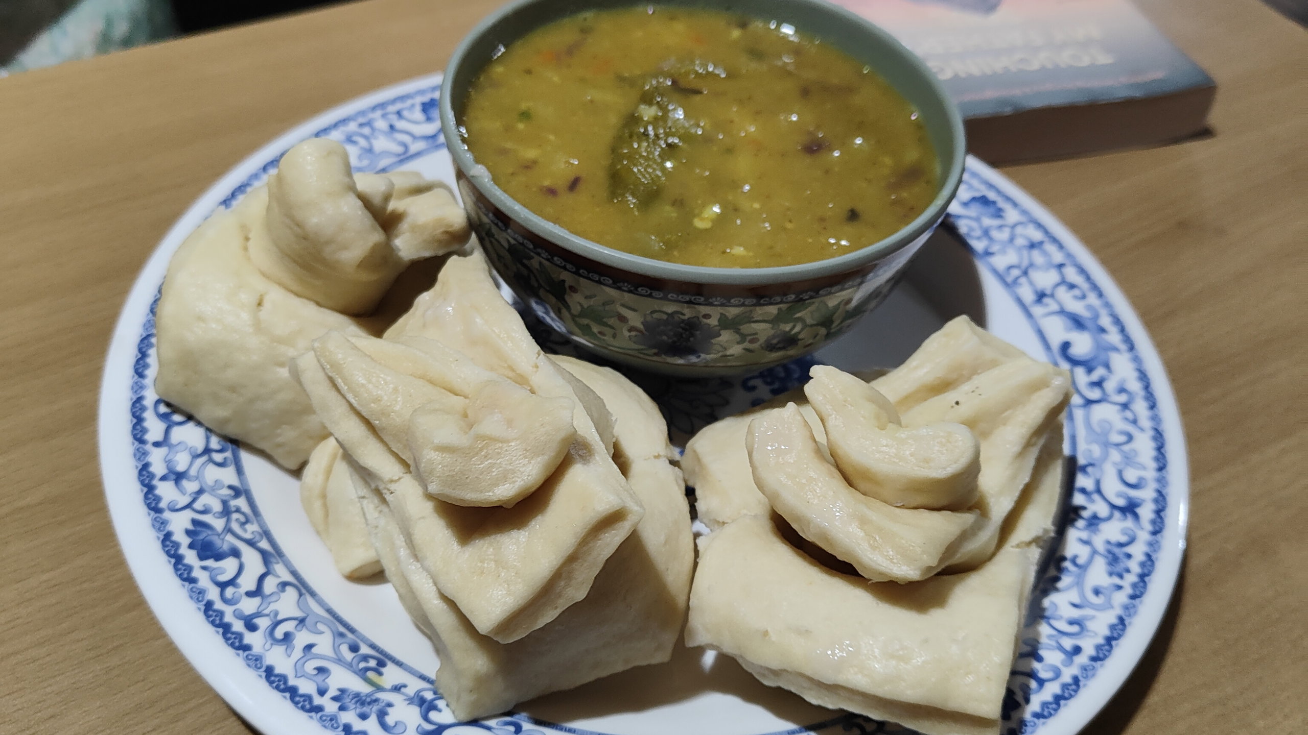 A plate of tingmos with lentil soup.